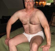 hairy dad sitting on bed