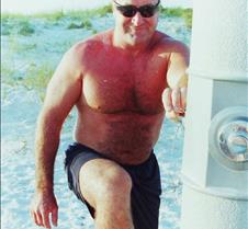 man rinsing off sand