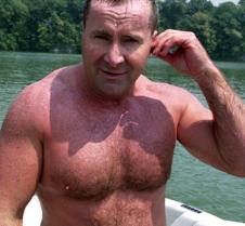 handsome man dripping wet lake skiing