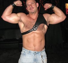 leather daddie flexing biceps