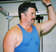 man leaning wall post gym workout