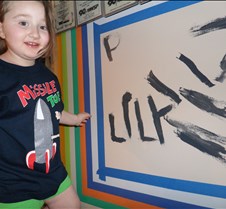 Lily writes her name and smiles