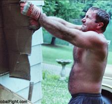 man tearing off siding
