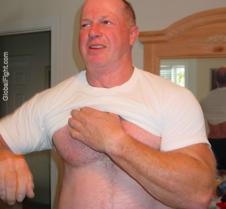 big powerlifter older man removing shirt