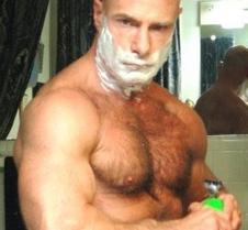 bald hairy man shaving bathroom