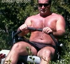 sweaty shirtless man mowing