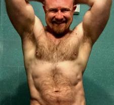redhead leather man flexing