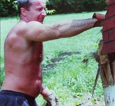 man tearing down house