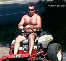 no shirt man mowing