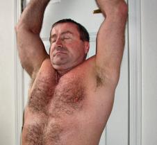 beefy man arms outstretched