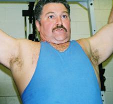 man lifting weights over head tanktop