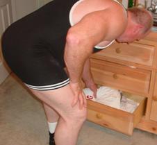powerlifter bending over tight singlet